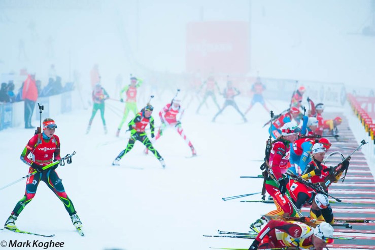 Women biathletes come out of the fog to shoot in the women's race of the biathlon world cup in Pokljuka.